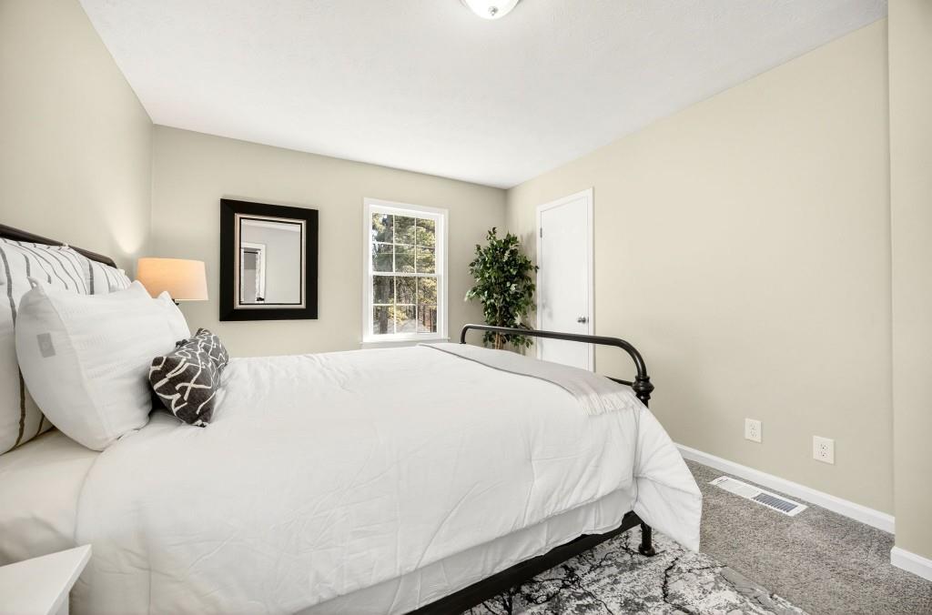 2545 Ridgecrest Drive Northwest Kennesaw, GA 30152 - Photo 14 of 20 a large bed sitting in a bedroom next to a window and dresser