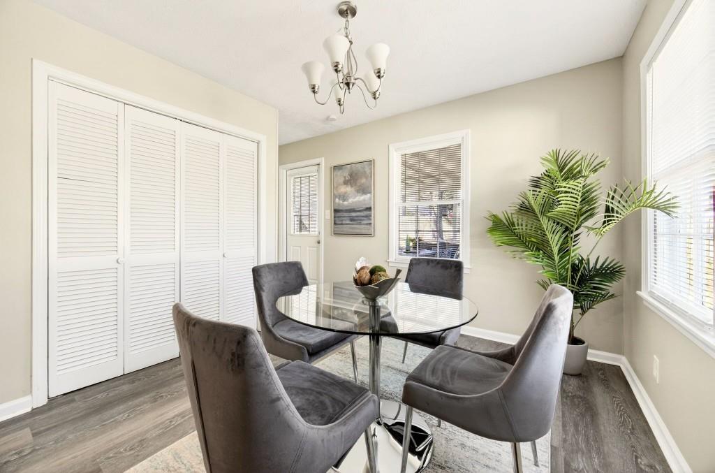 2545 Ridgecrest Drive Northwest Kennesaw, GA 30152 - Photo 8 of 20 a dining room with furniture potted plants and wooden floor