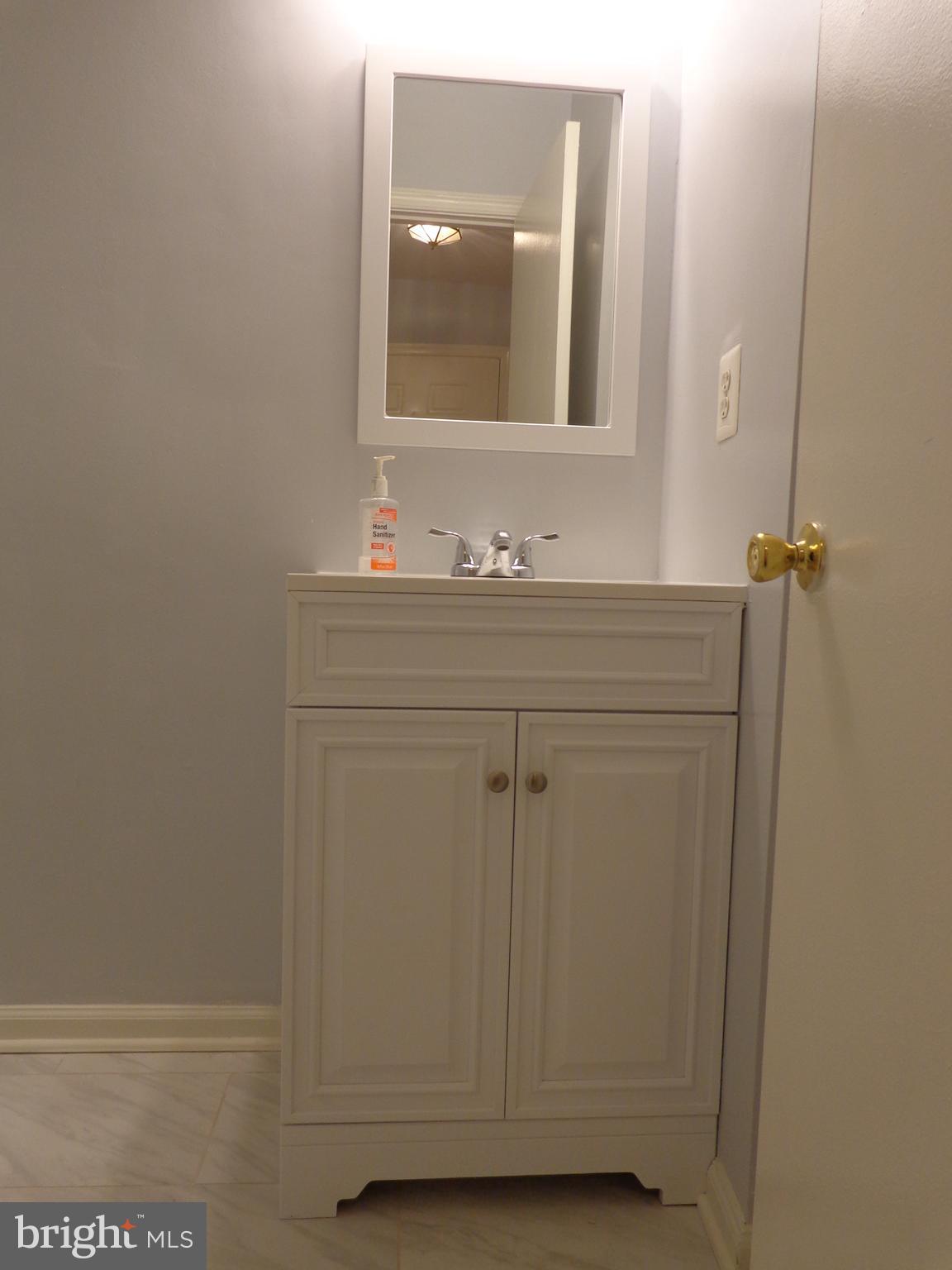 5565 Peppercorn Drive Burke, VA 22015 - Photo 23 of 41 a bathroom with a sink and a mirror