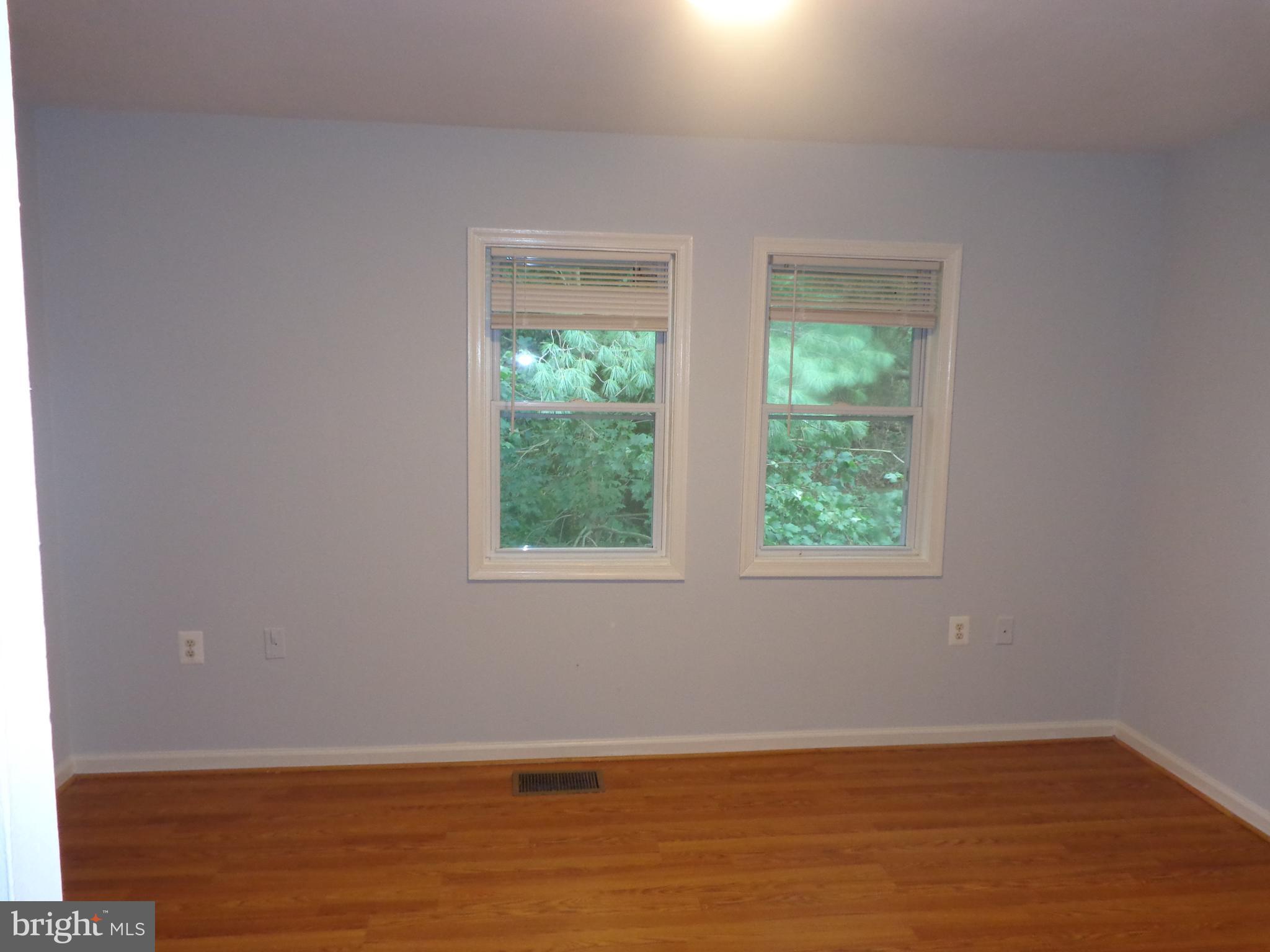 5565 Peppercorn Drive Burke, VA 22015 - Photo 26 of 41 an empty room with wooden floor and windows