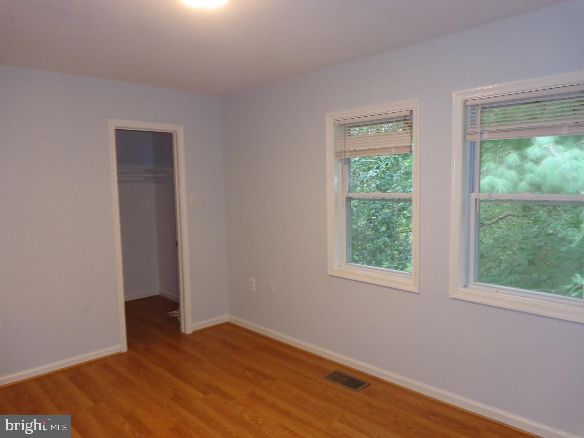 5565 Peppercorn Drive Burke, VA 22015 - Photo 27 of 41 a view of an empty room with wooden floor and windows