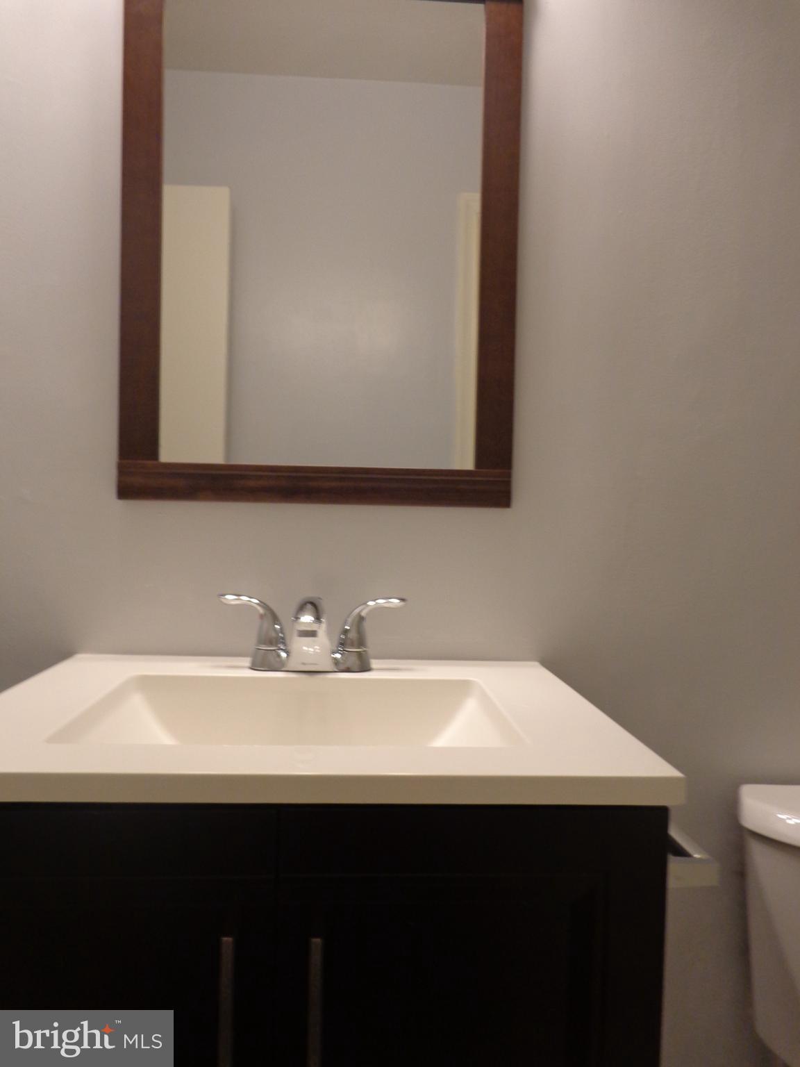 5565 Peppercorn Drive Burke, VA 22015 - Photo 31 of 41 a bathroom with a sink and a mirror