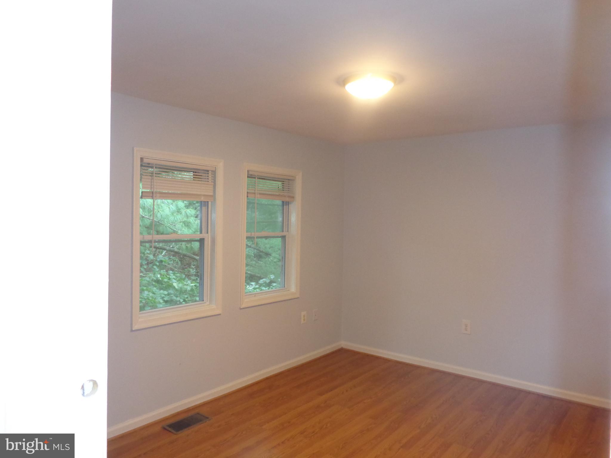 5565 Peppercorn Drive Burke, VA 22015 - Photo 32 of 41 an empty room with wooden floor and windows