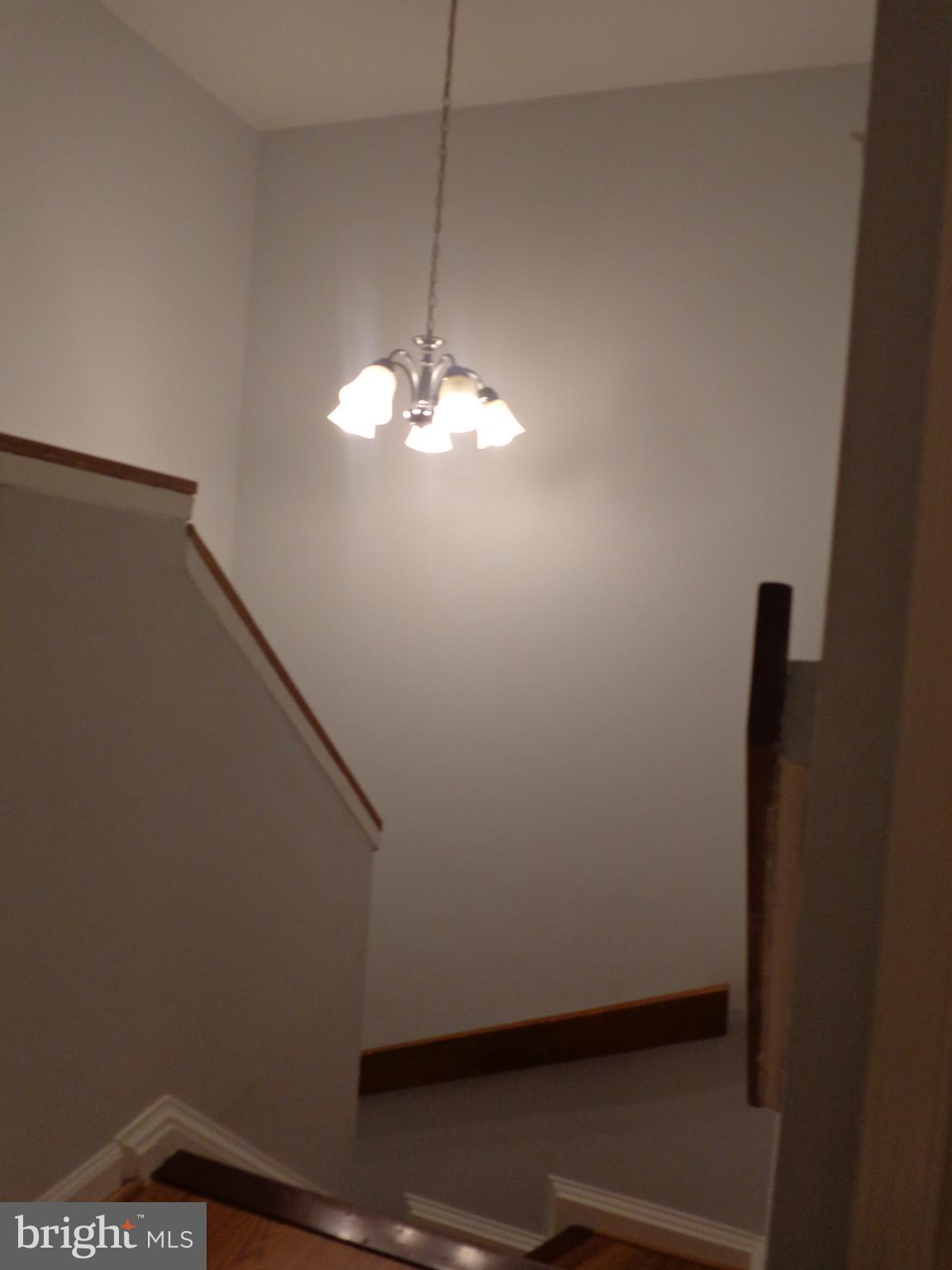 5565 Peppercorn Drive Burke, VA 22015 - Photo 33 of 41 a view of a room with a chandelier fan and wooden floor