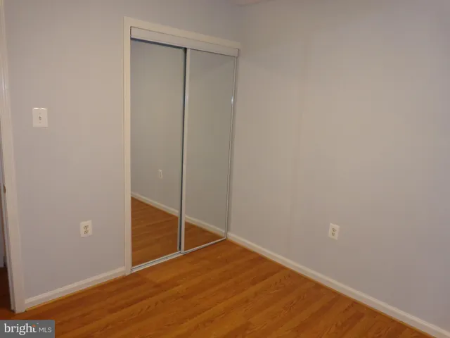 a view of a small space with wooden floor and a window