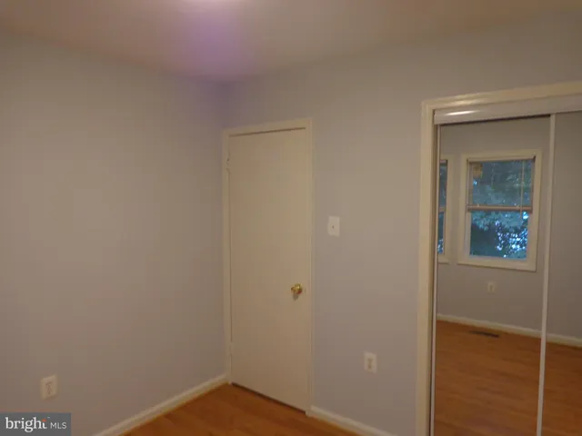 a view of staircase with railing and white walls