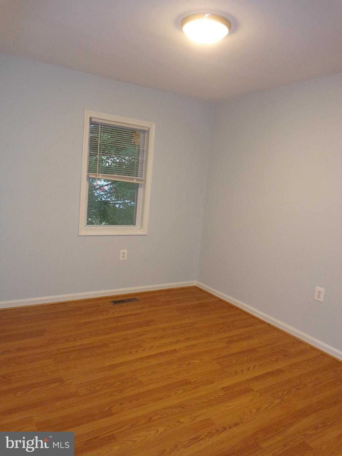 5565 Peppercorn Drive Burke, VA 22015 - Photo 38 of 41 a view of an empty room with wooden floor and a window