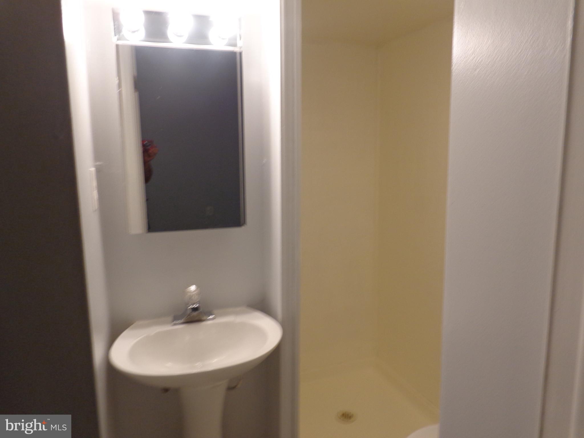 5565 Peppercorn Drive Burke, VA 22015 - Photo 9 of 41 a bathroom with a sink and a mirror