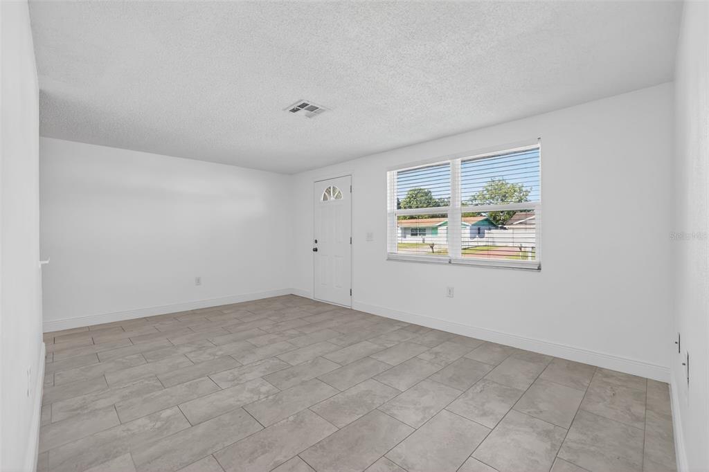 10914 Leeds Road Port Richey, FL 34668 - Photo 14 of 24 an empty room with windows