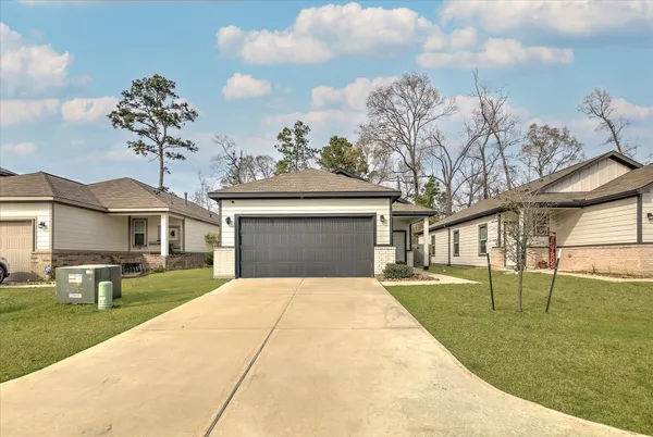 a front view of a house with a garden and yard