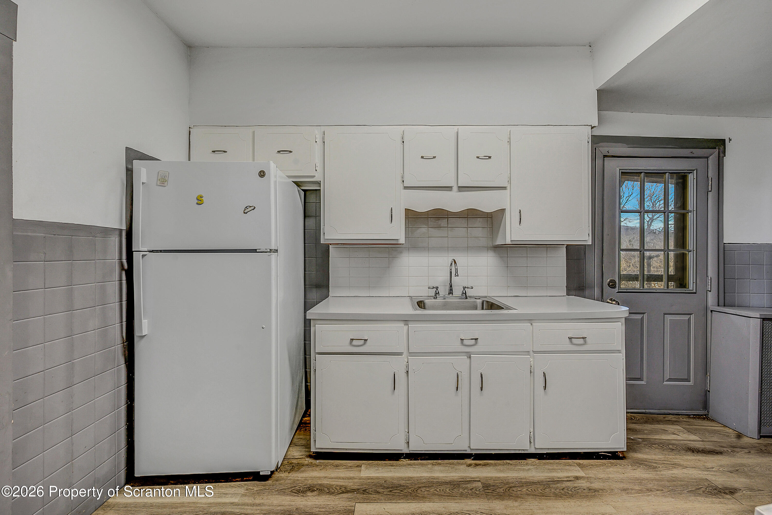 905 Albright Avenue Scranton, PA 18508 - Photo 14 of 56 a kitchen with white cabinets and refrigerator