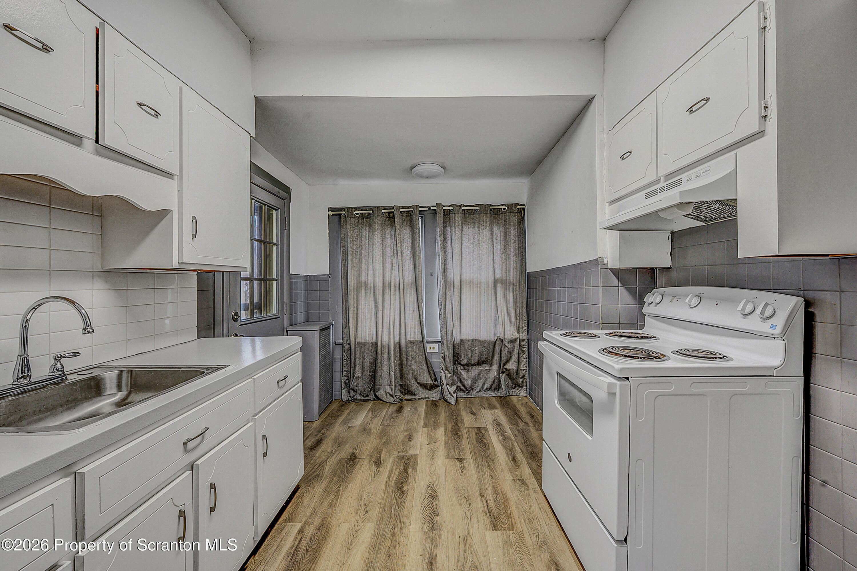 905 Albright Avenue Scranton, PA 18508 - Photo 15 of 56 a kitchen that has a sink and a stove with white countertops