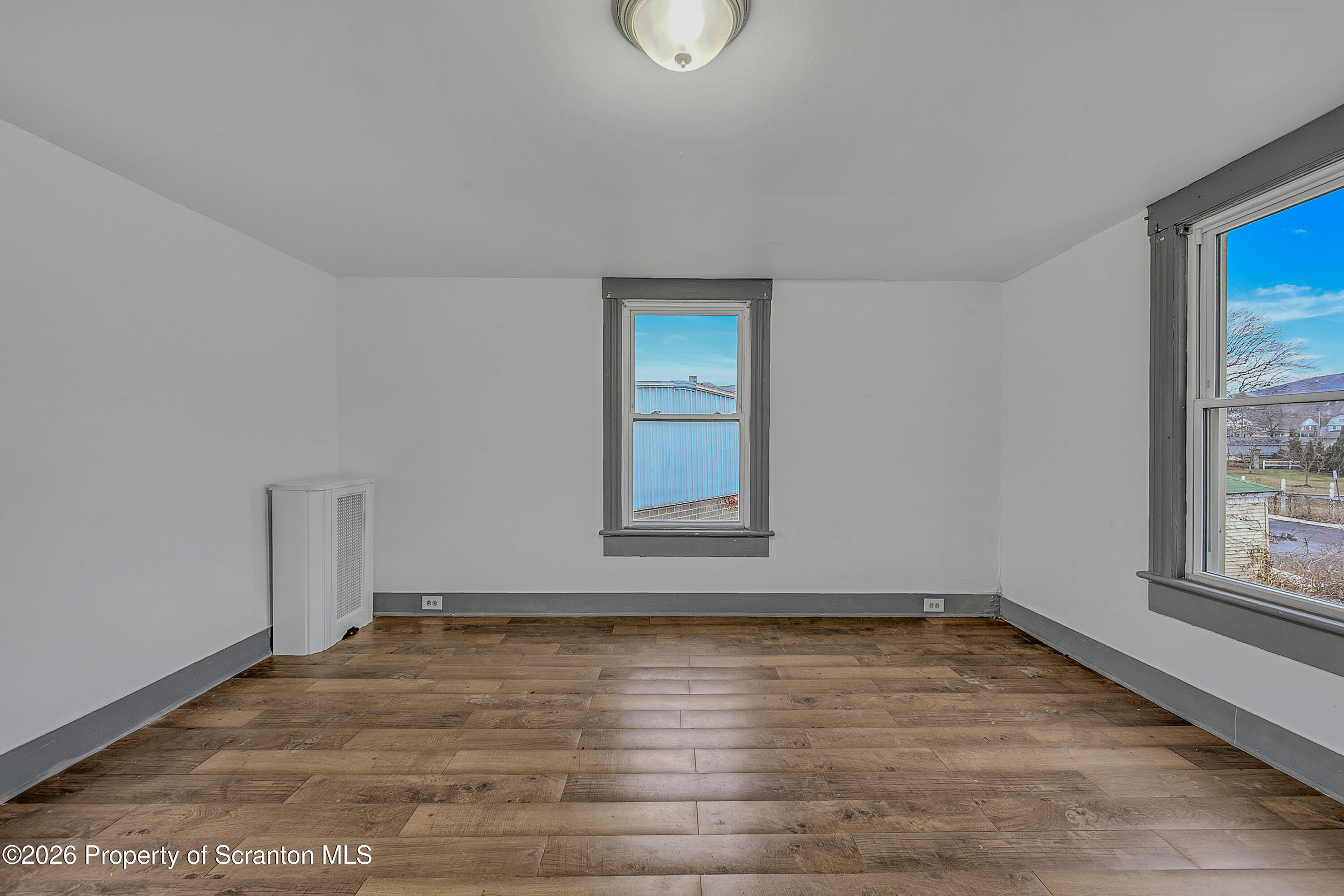 905 Albright Avenue Scranton, PA 18508 - Photo 20 of 56 an empty room with wooden floor and windows