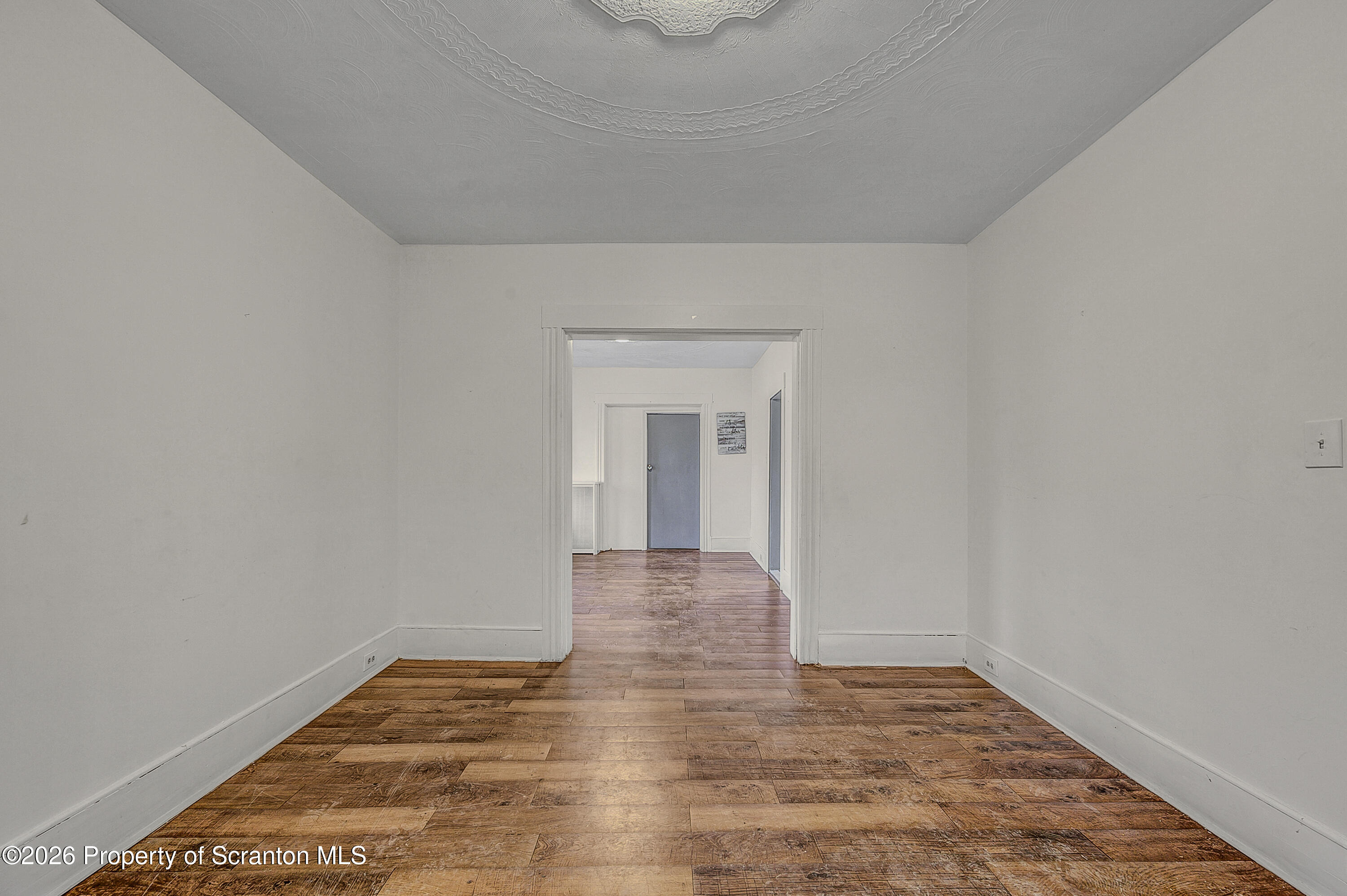 905 Albright Avenue Scranton, PA 18508 - Photo 27 of 56 a view of a hallway with wooden floor and a window