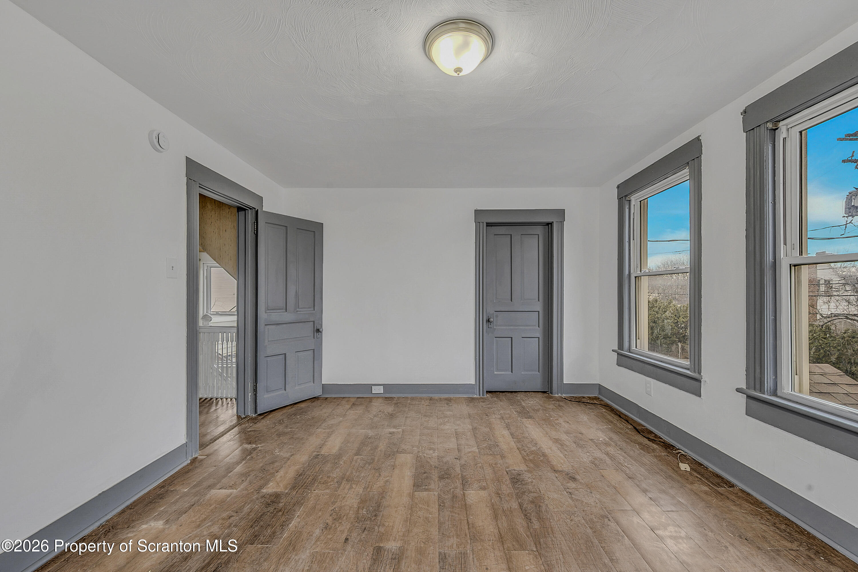 905 Albright Avenue Scranton, PA 18508 - Photo 33 of 56 an empty room with wooden floor and windows