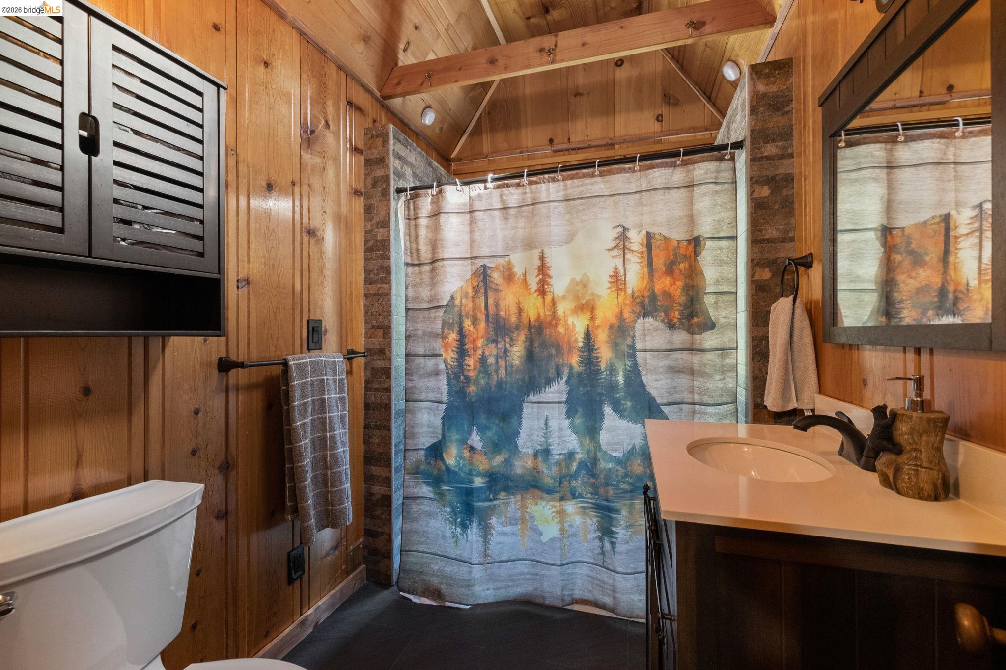 26175 Janice Way Long Barn, CA 95335 - Photo 15 of 23 Full bathroom featuring wooden walls, lofted ceiling with beams, vanity, and wood ceiling