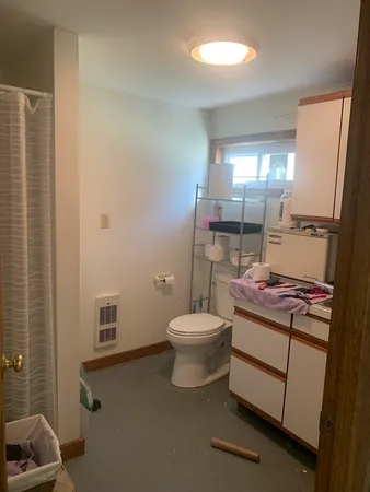 a bathroom with a toilet a sink and a mirror
