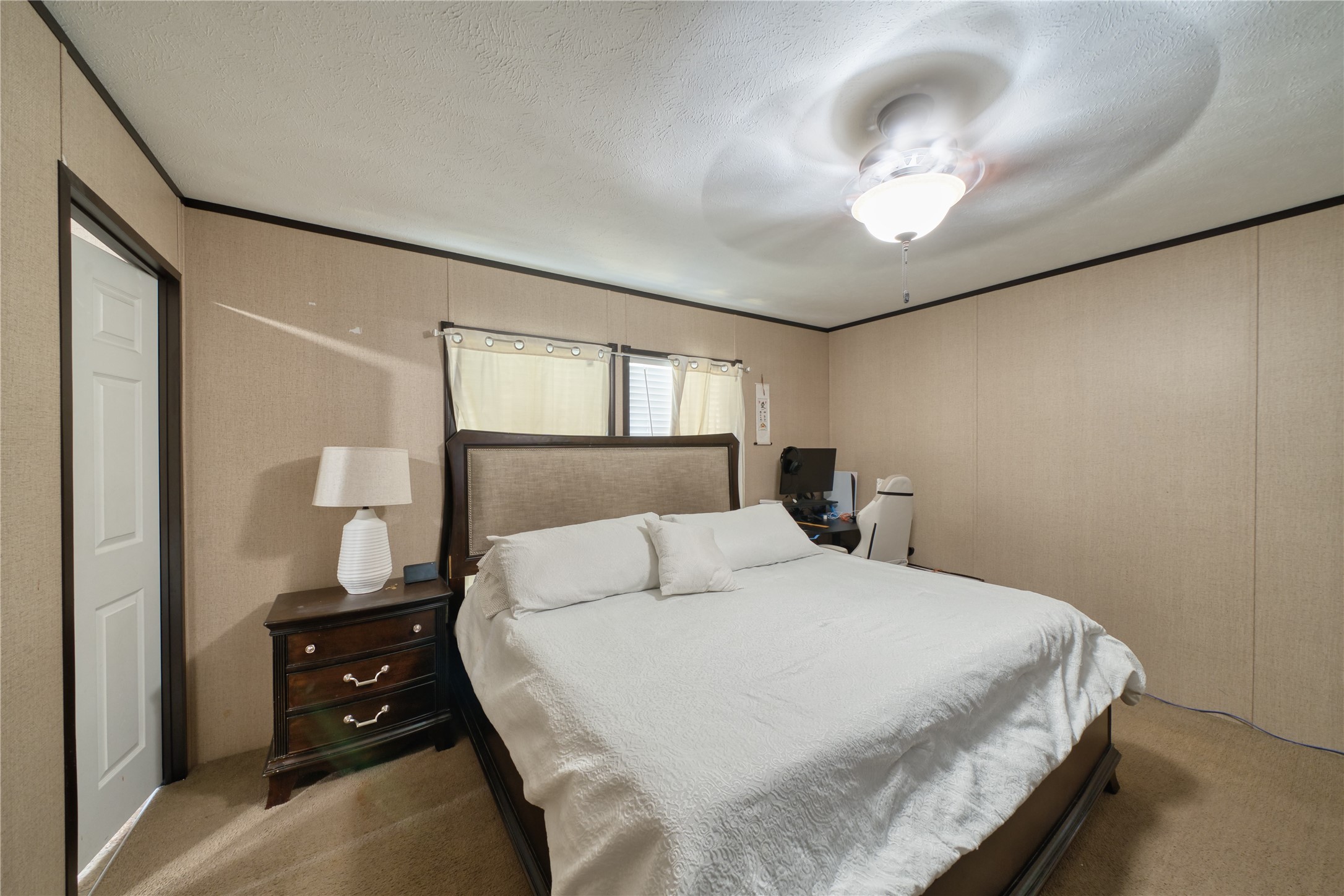 103 County Road 370 Splendora, TX 77372 - Photo 20 of 32 a bedroom with a bed and a chandelier