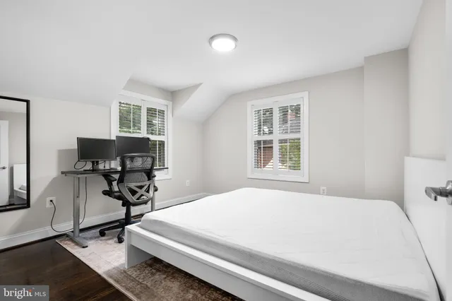 a bedroom with a bed a desk and chair