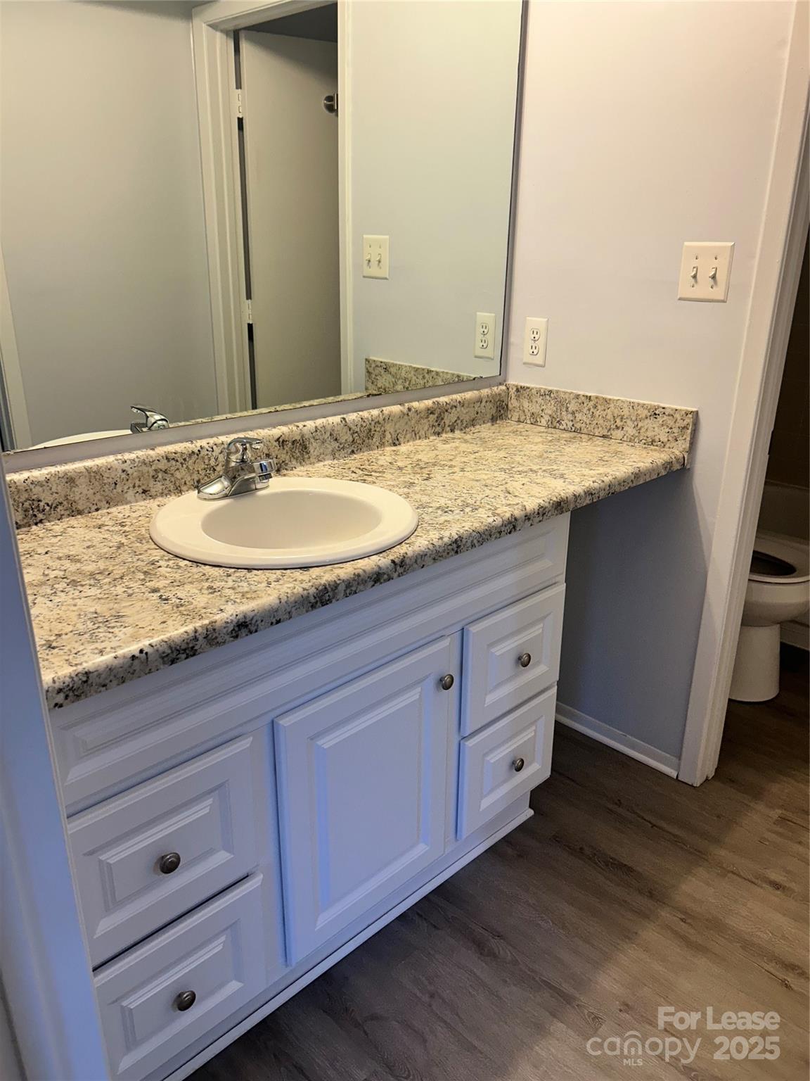 4936 Sardis Road, Unit A Charlotte, NC 28270 - Photo 11 of 21 a bathroom with a granite countertop sink and a mirror