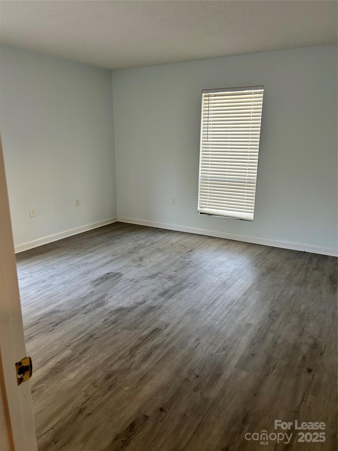 4936 Sardis Road, Unit A Charlotte, NC 28270 - Photo 13 of 21 an empty room with wooden floor and windows