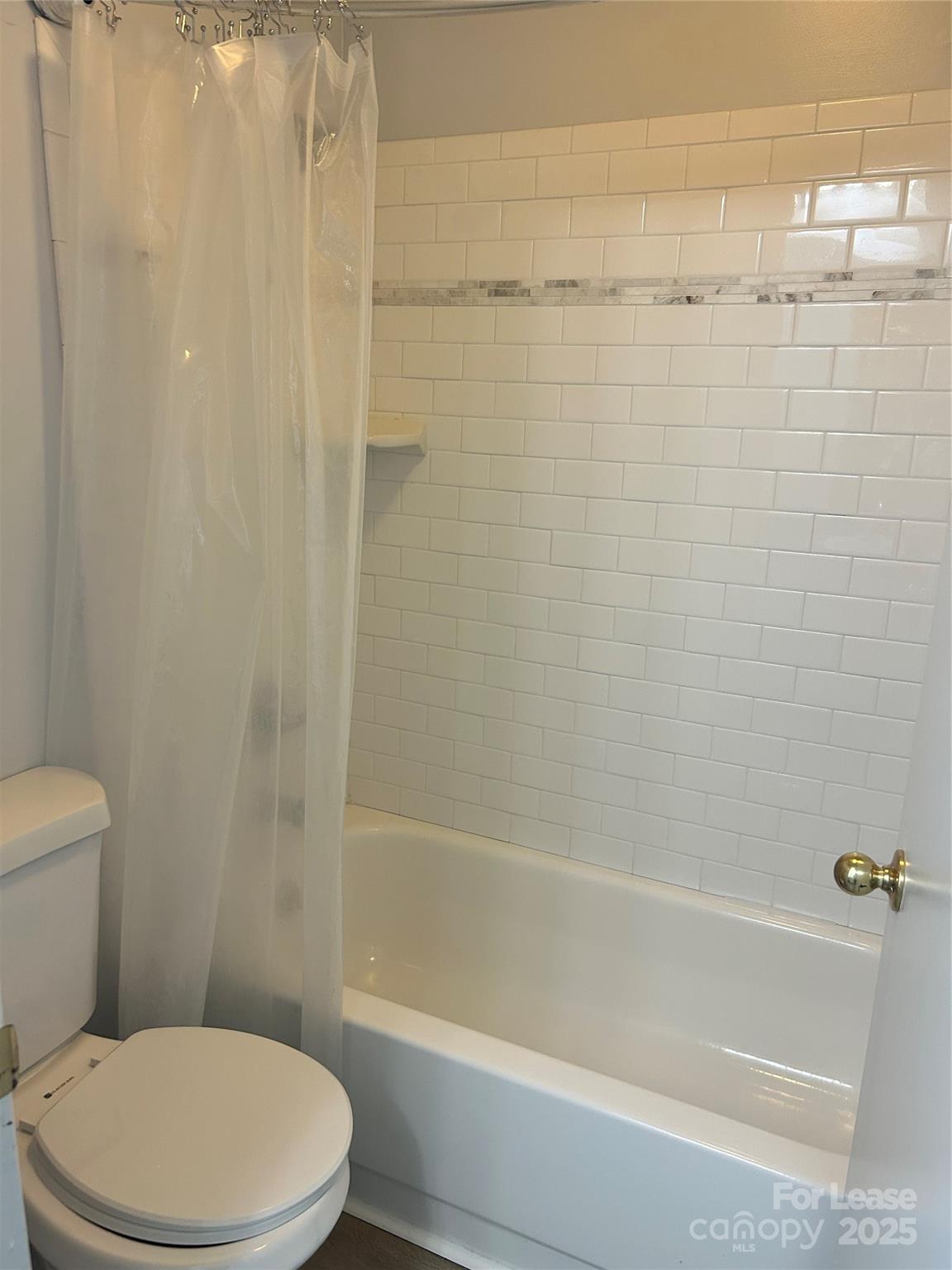 4936 Sardis Road, Unit A Charlotte, NC 28270 - Photo 14 of 21 a white toilet and tub sitting next to a bathroom sink