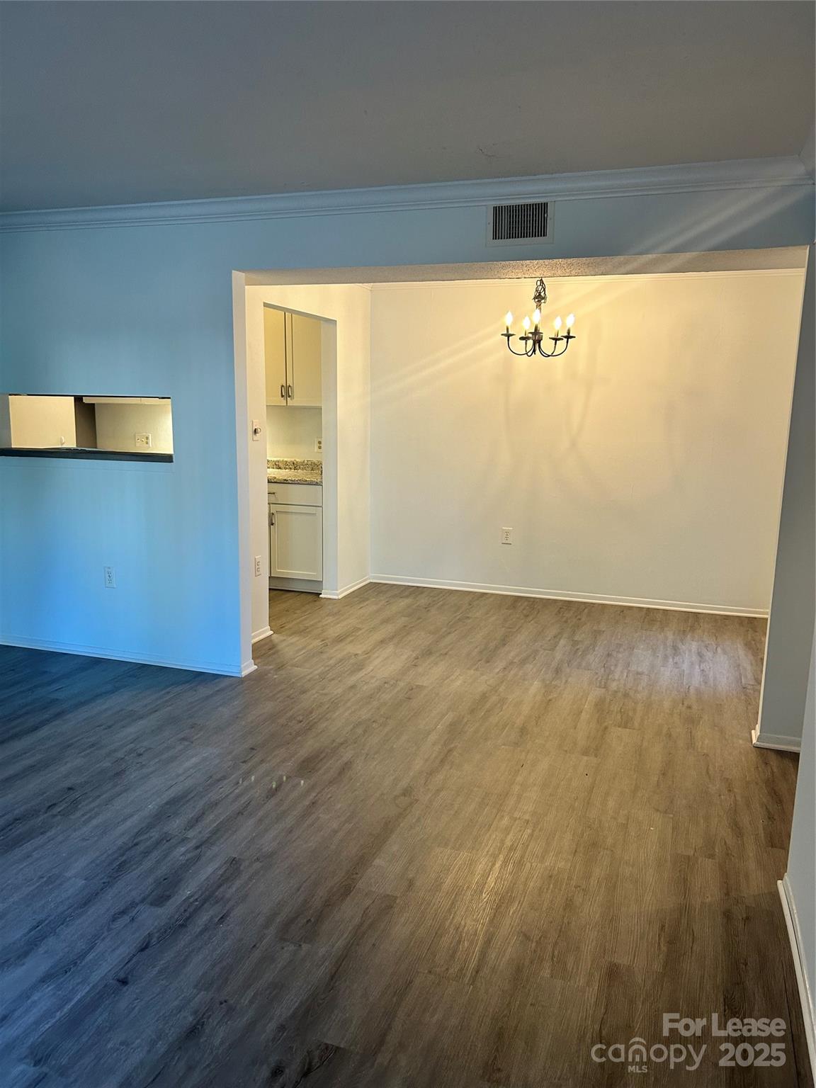 4936 Sardis Road, Unit A Charlotte, NC 28270 - Photo 3 of 21 a view of an empty room with wooden floor and a window