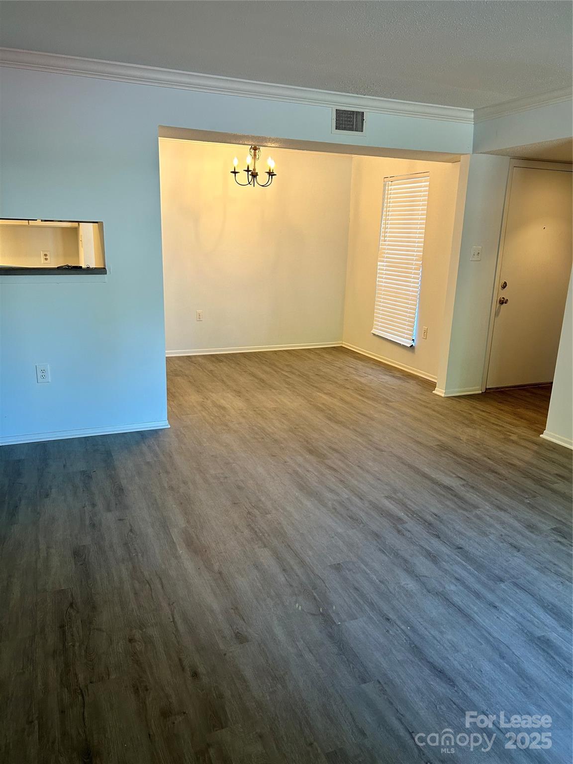 4936 Sardis Road, Unit A Charlotte, NC 28270 - Photo 4 of 21 an empty room with wooden floor and windows