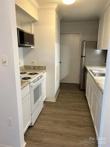 a kitchen with a stove and a microwave