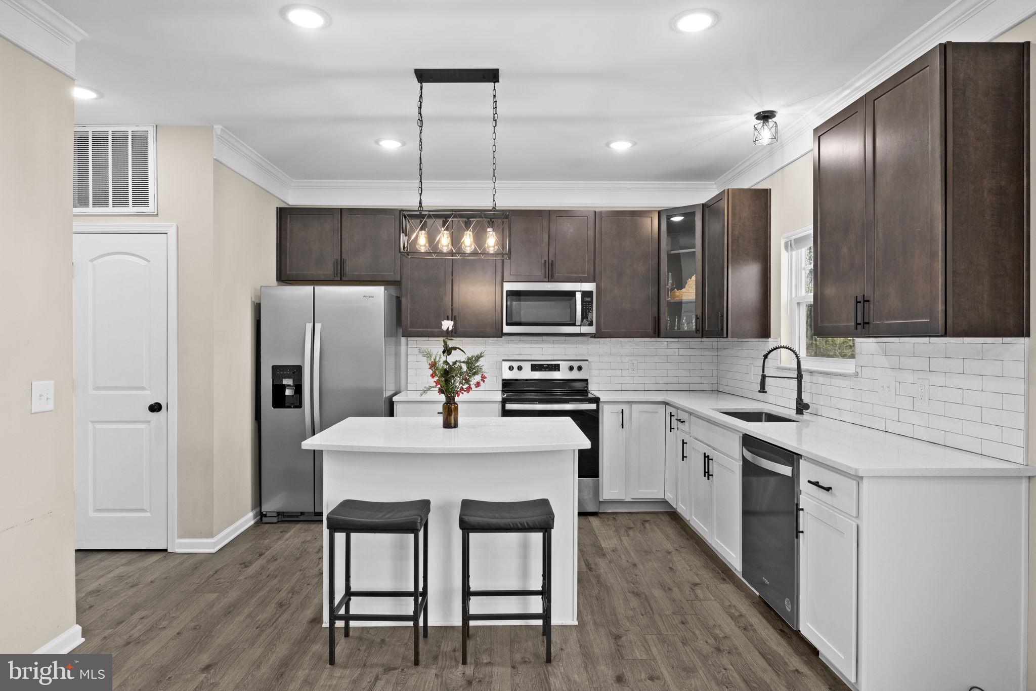 5835 Smith Station Road Fredericksburg, VA 22407 - Photo 16 of 31 a kitchen with refrigerator a sink and chairs