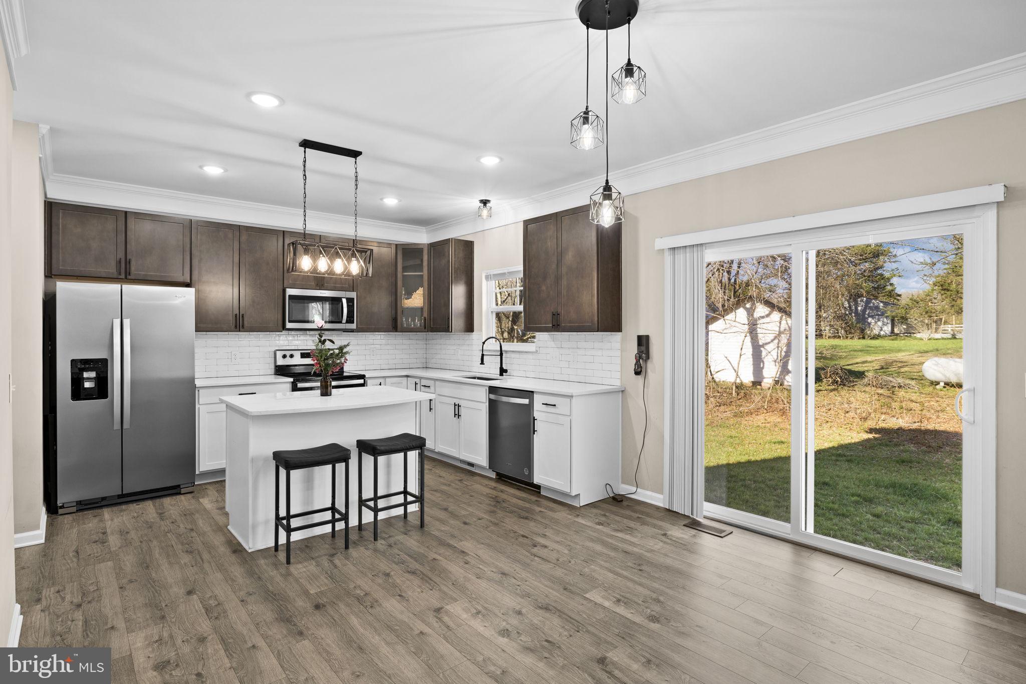 5835 Smith Station Road Fredericksburg, VA 22407 - Photo 17 of 31 a kitchen with refrigerator cabinets and wooden floor