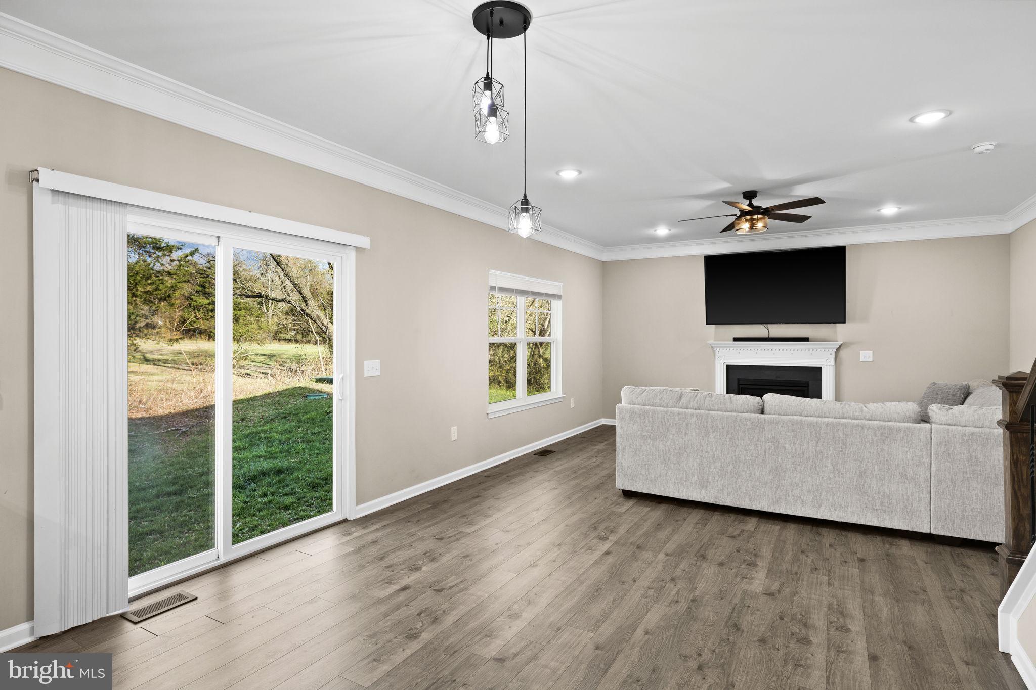 5835 Smith Station Road Fredericksburg, VA 22407 - Photo 19 of 31 a living room with furniture and a flat screen tv