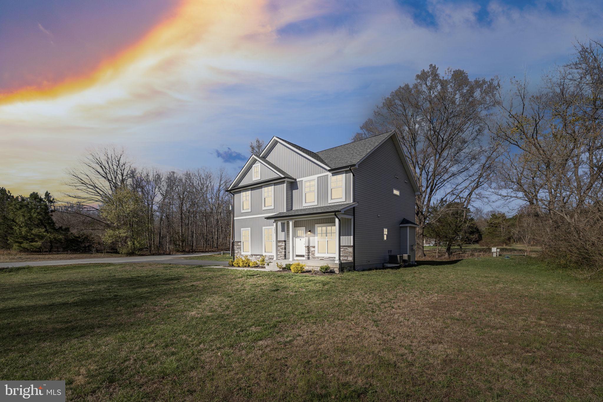 5835 Smith Station Road Fredericksburg, VA 22407 - Photo 2 of 31 a front view of a house with a yard and trees