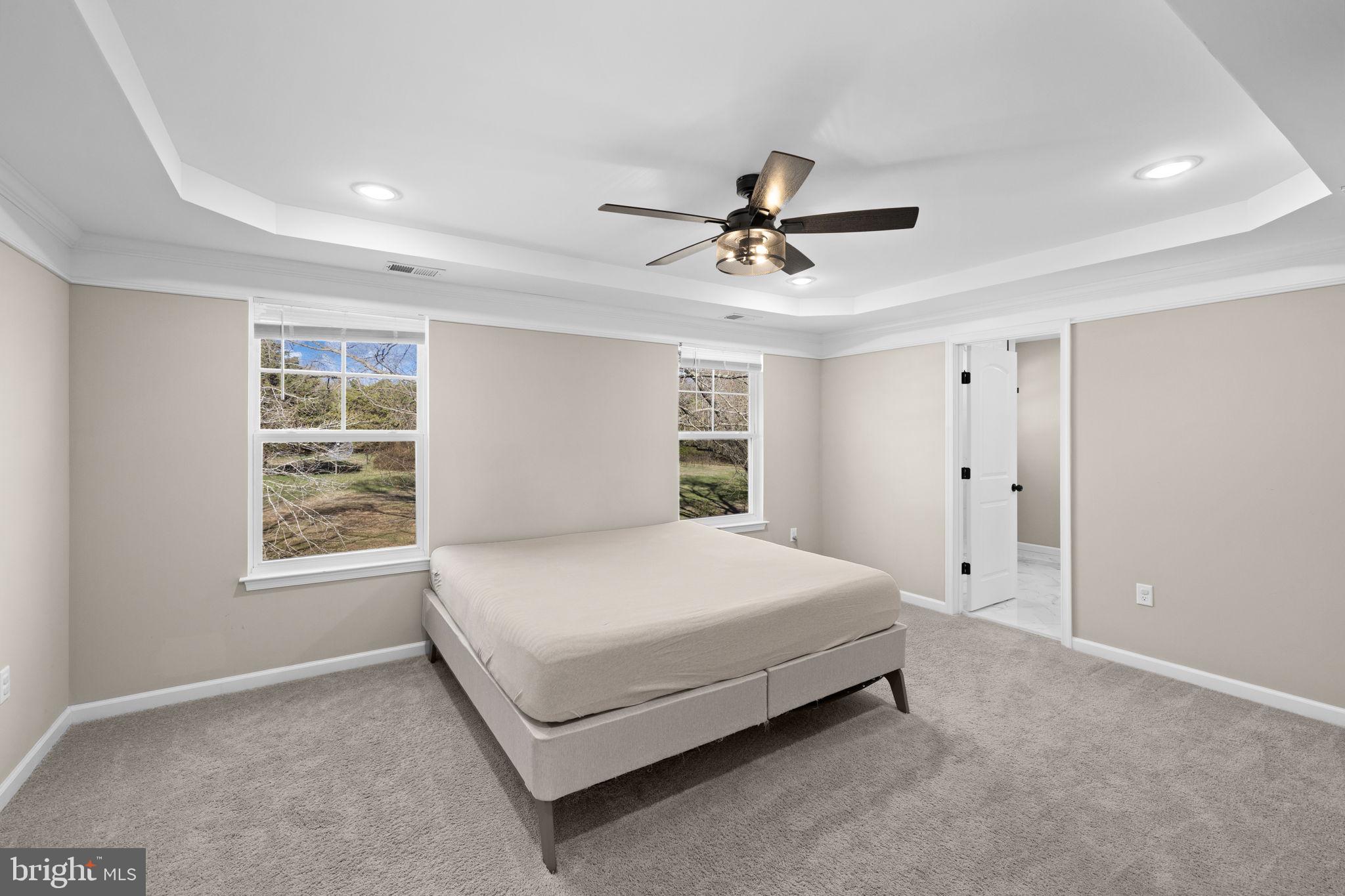 5835 Smith Station Road Fredericksburg, VA 22407 - Photo 21 of 31 a bed sitting in a spacious bedroom next to a window