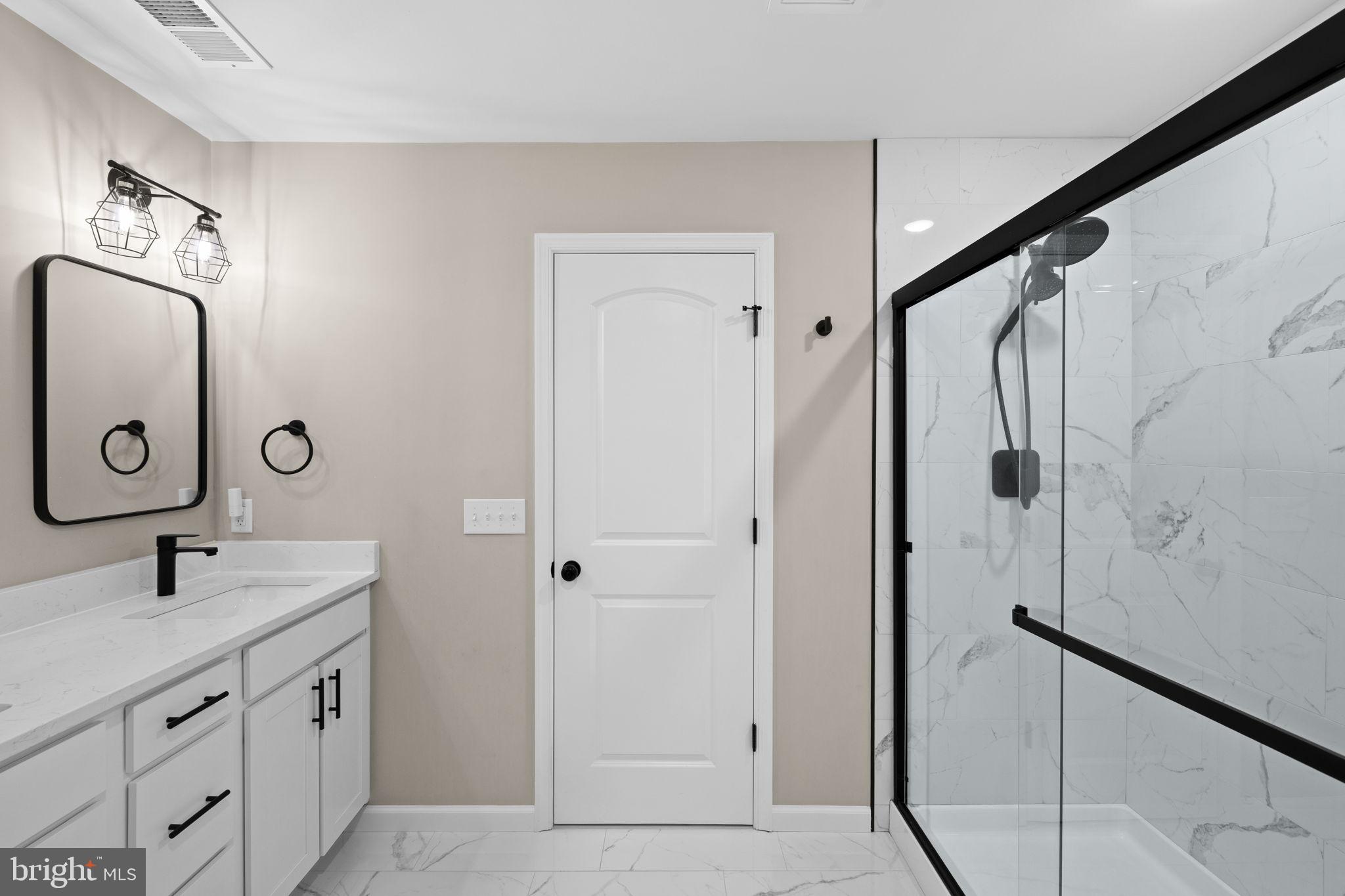5835 Smith Station Road Fredericksburg, VA 22407 - Photo 23 of 31 a bathroom with a granite countertop sink a mirror a vanity and a shower