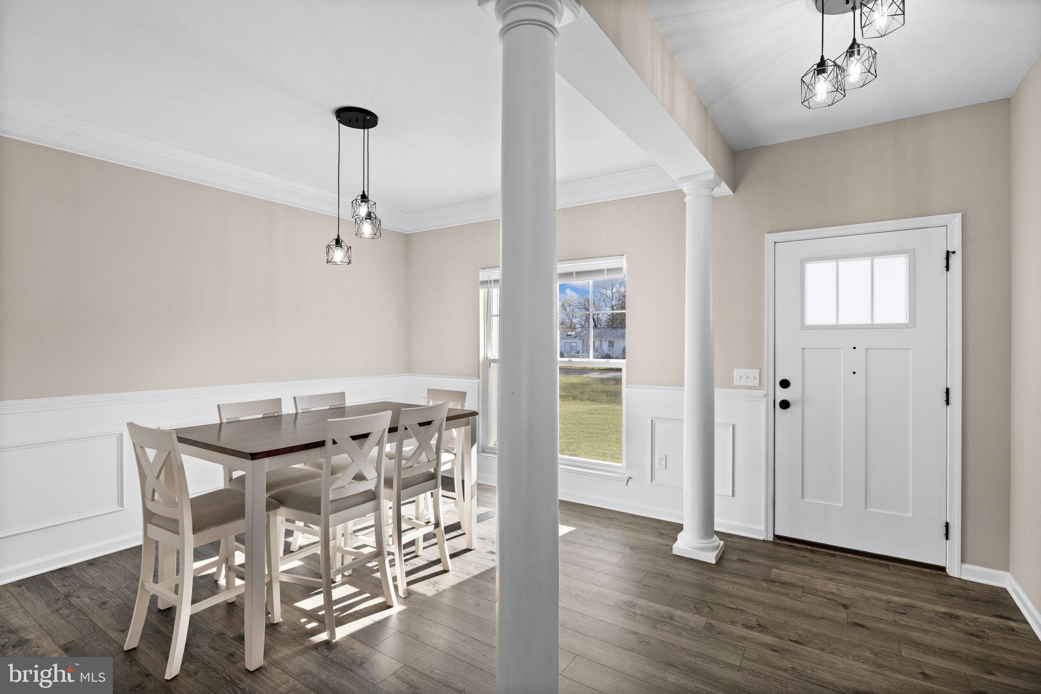 5835 Smith Station Road Fredericksburg, VA 22407 - Photo 3 of 31 a view of a dining room with furniture and wooden floor