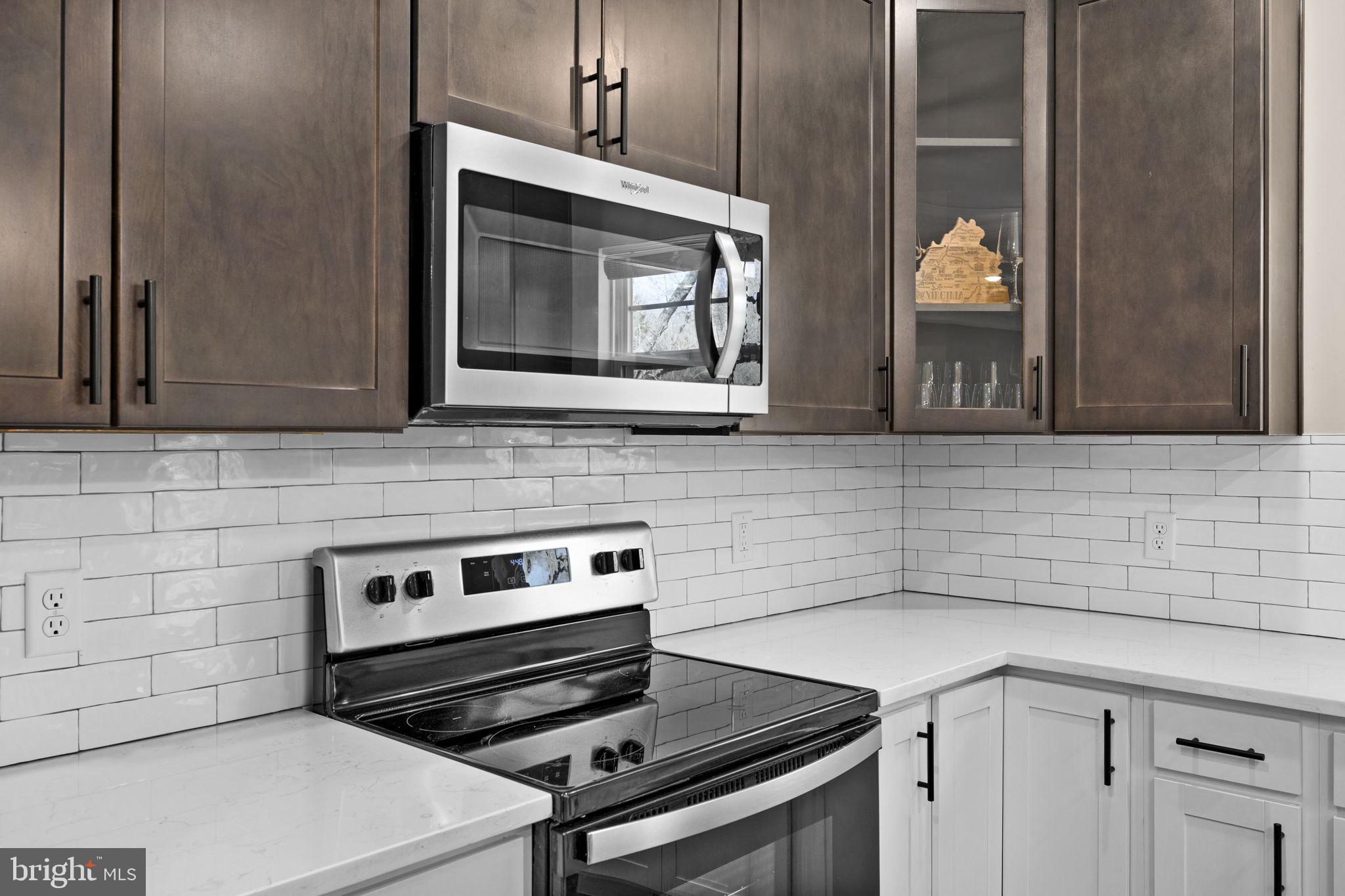 5835 Smith Station Road Fredericksburg, VA 22407 - Photo 5 of 31 a kitchen with a stove and a microwave