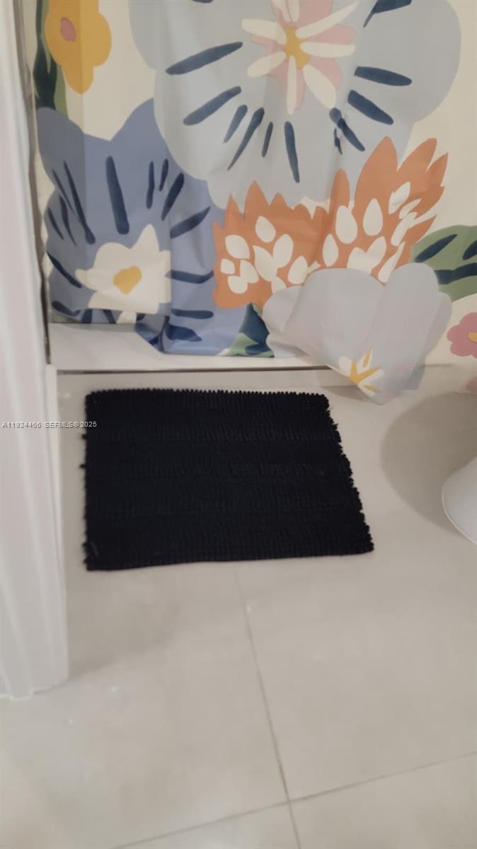 2820 Southwest 13th Street, Unit 4 Miami, FL 33145 - Photo 12 of 17 a bathroom with a sink and a mirror