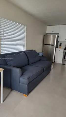 a living room with a couch and a ceiling fan