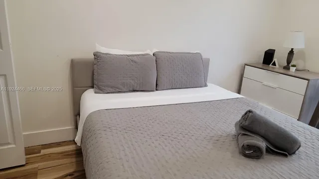 a bedroom with a bed and a chair