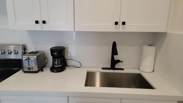 a kitchen with a sink and a stove