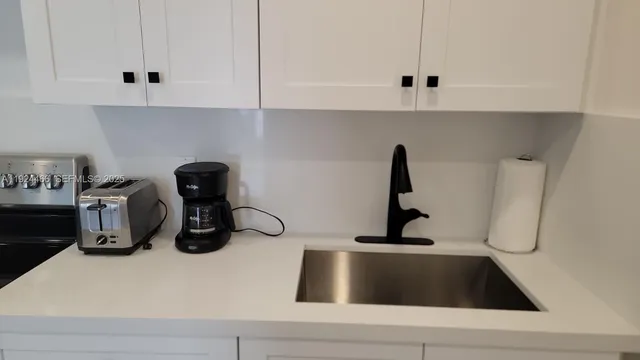 a kitchen with a sink and a stove