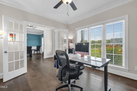 a view of a workspace with furniture and a window