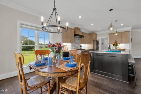 a spacious bedroom with a bed and a table with wooden floor