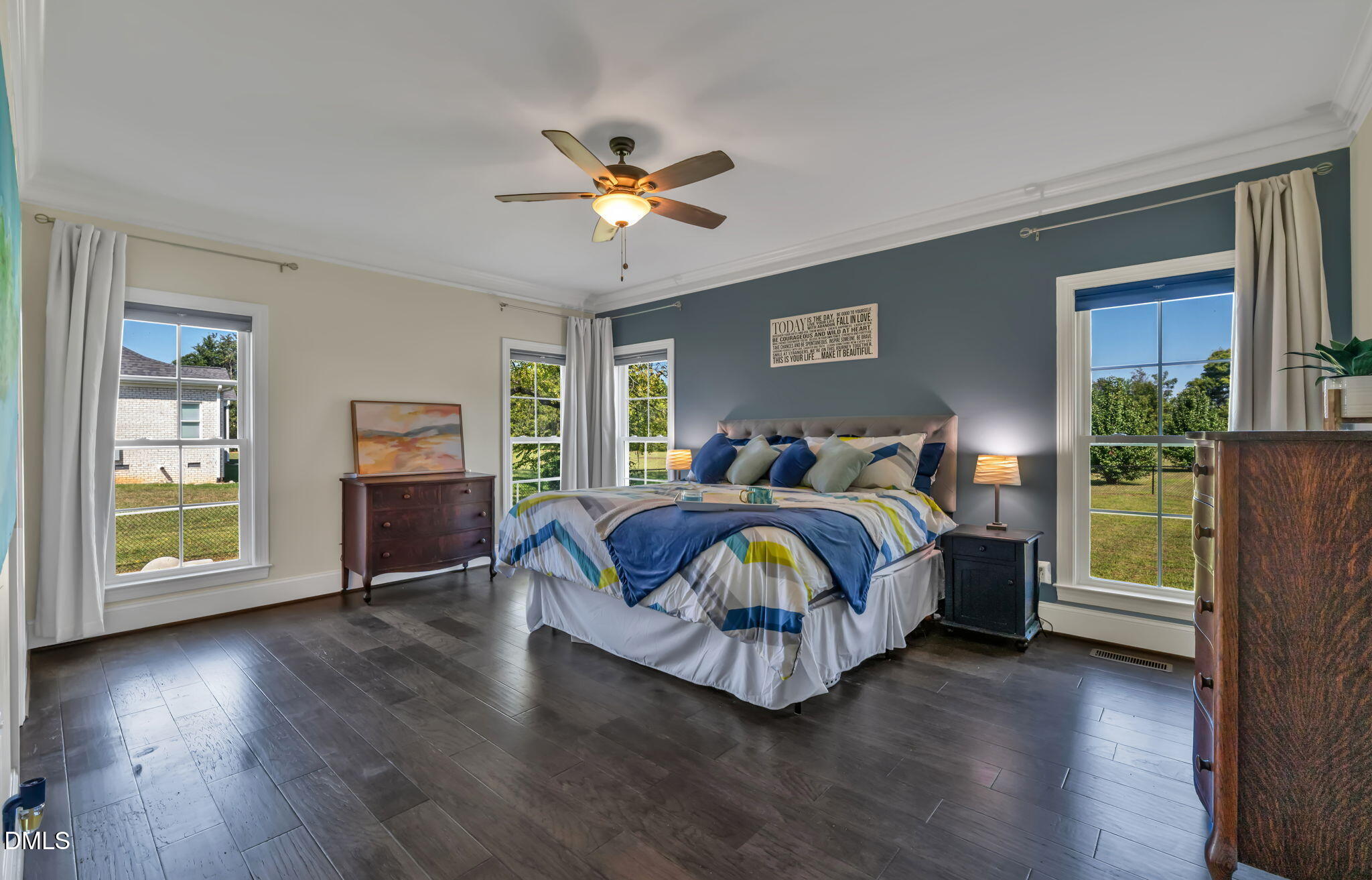 106 Garrison Farm Road Mebane, NC 27302 - Photo 17 of 46 a spacious bedroom with a bed and a table with wooden floor