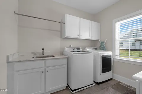 a utility room with closet dryer and washer
