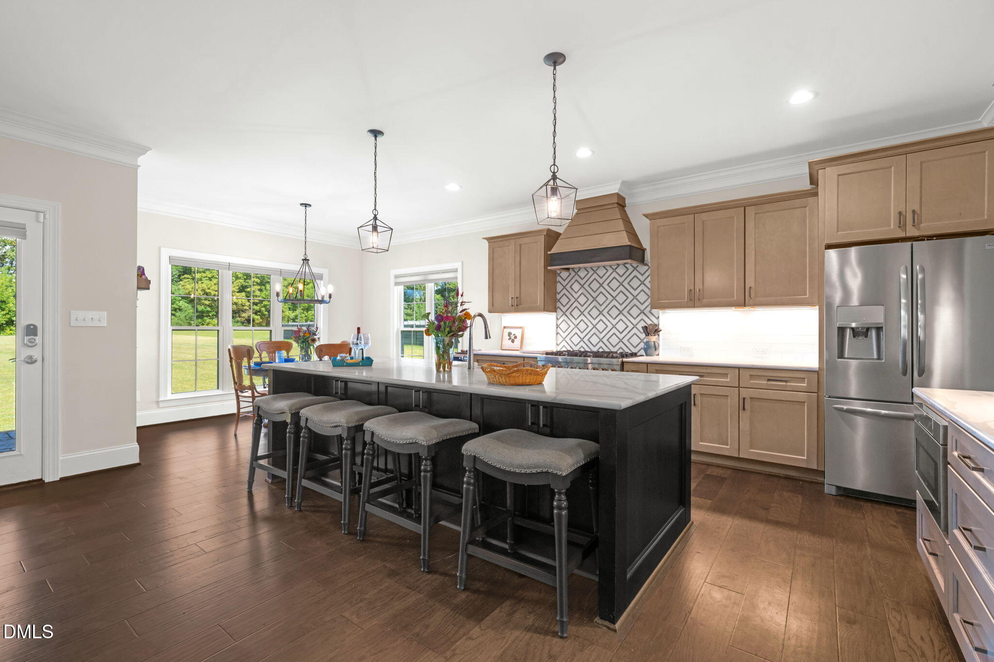 106 Garrison Farm Road Mebane, NC 27302 - Photo 3 of 46 a kitchen with stainless steel appliances granite countertop a table chairs stove and wooden floor