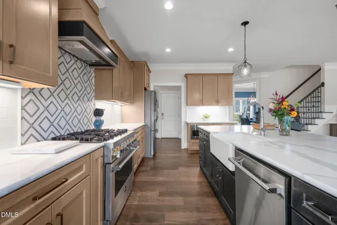a kitchen with stainless steel appliances granite countertop a stove and a refrigerator
