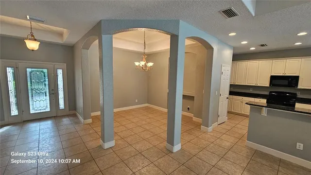 a view of a hallway with wooden cabinet and glass door