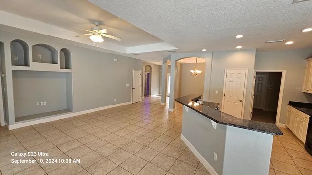 a large bathroom with a large mirror vanity and a sink